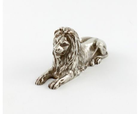 A silver finial, part marked, possibly by Gibson and Langman, circa 1910, modelled as recumbent lion, length 12cm, approx. we