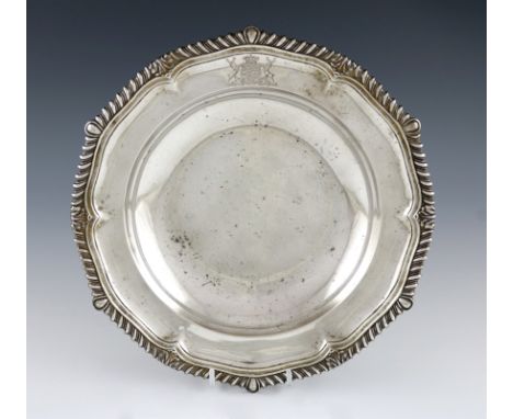 A George III silver soup plate, by Paul Storr, London 1816, circular form, foliate and gadroon border, engraved with an armor