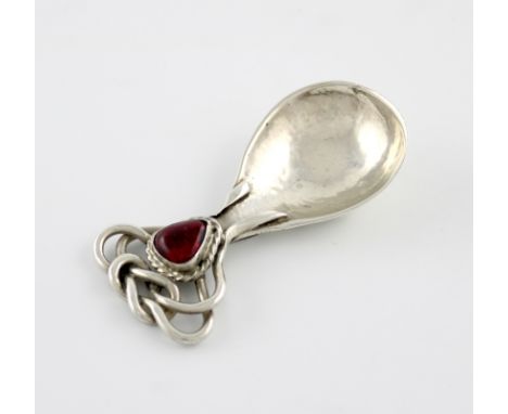 By Omar Ramsden, an Arts and Crafts silver and enamel caddy spoon, London 1927, fig-shaped bowl with spot hammered decoration