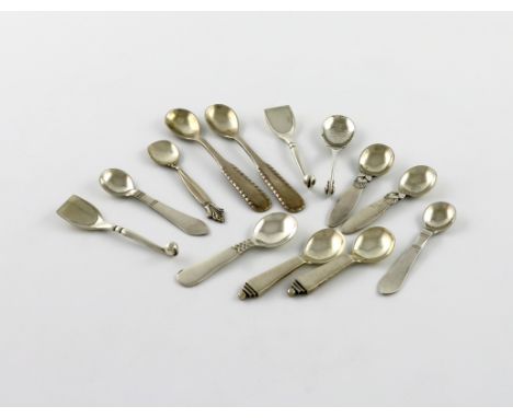 By Georg Jensen, a collection of silver salt spoons, comprising: a pair of Pyramid pattern, a pair of Rope pattern, a pair of