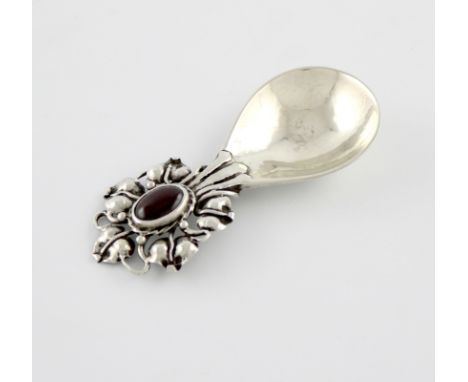 By Omar Ramsden, an Arts and Crafts silver caddy spoon, London 1921, fig-shaped bowl with spot hammered decoration, the inter