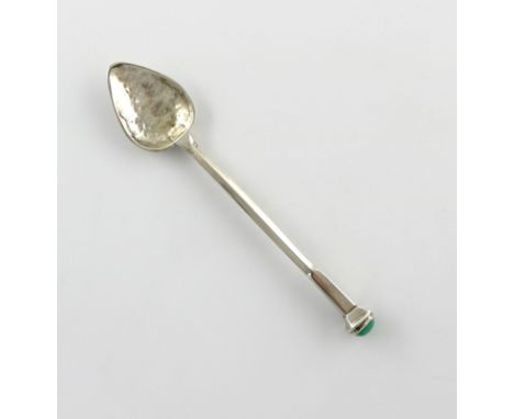 By Winifred King and Co, an Arts and Crafts silver spoon, Birmingham 1925, spot-hammered tapering oval bowl, faceted stem wit