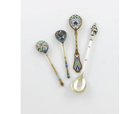 A small collection of four Russian silver spoons, comprising: three silver-gilt and enamel spoons, two with twisted stems, th
