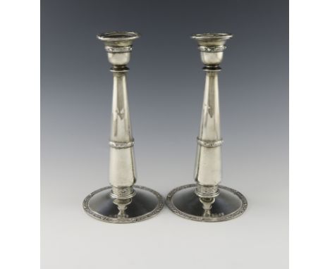 A pair of Scottish silver candlesticks, by R and W Sorley, Glasgow 1915, tapering circular form, Celtic borders, removable dr