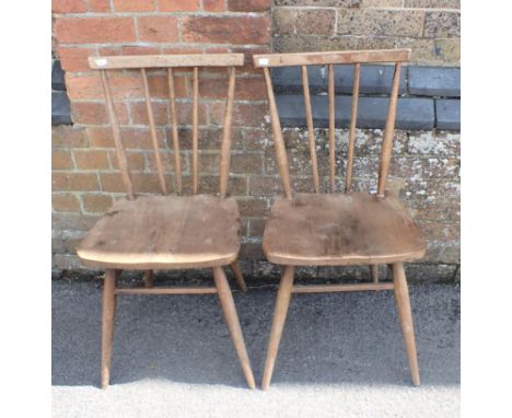A PAIR OF ERCOL STICK-BACK DINING CHAIRS one retaining blue label (for restoration)