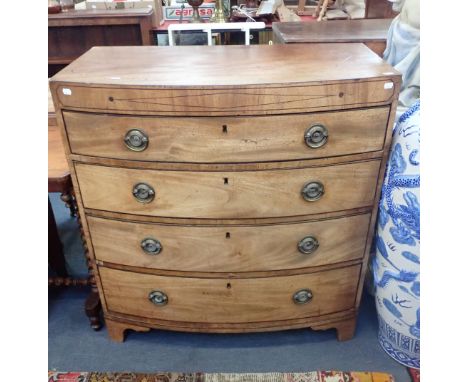 A REGENCY FIGURED MAHOGANY BOWFRONT CHEST OF DRAWERS with (replaced) pressed brass handles, on bracket feet 92cm wide (faded,