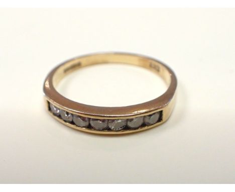 AN 18CT GOLD AND DIAMOND ENGAGEMENT RING the seven stones in channel setting