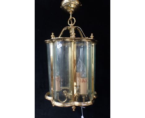 A BRASS-FRAMED HALL LANTERN with curved glazing panels, and three-light inner pendant 52cm drop