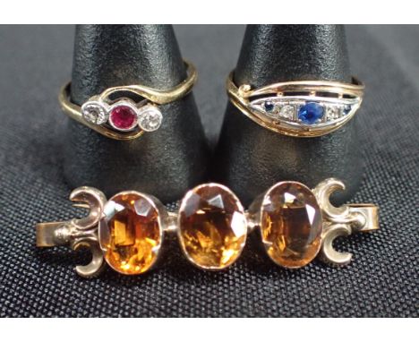A RUBY AND DIAMOND GOLD RING with a sapphire and gold ring and a rolled gold citrine brooch