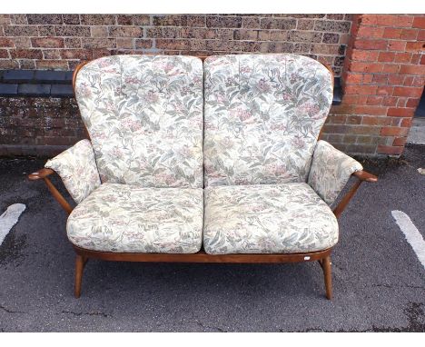 AN ERCOL WINDSOR TWO SEATER SOFA medium finish, with fire labels to cushions (needs cleaning/re-covering)140cm wide