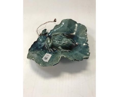 A ceramic frog modelled on a leaf with inscription on lable verso inscribed "Sold to "A" by the present Princess of Wales, no