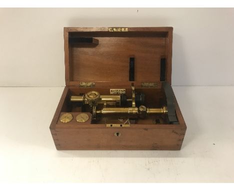 A circa 1900 mahogany cased lacquered brass and anodised monocular microscope, the base engraved "J Milner &amp; T.B. Winter 