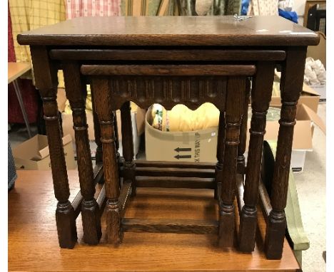 A modern oak nest of three occasional tables, a mahogany pot cupboard, fabric covered fire screen, towel rail, Lloyd Loom sty