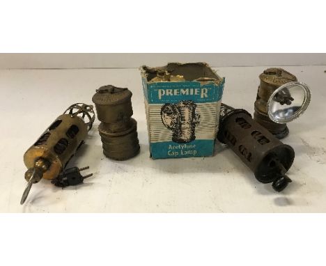 Three Premier Acetylene Cape lamps, one with cardboard box, together with a brass J. Lucas Limited hanging lamp and another s