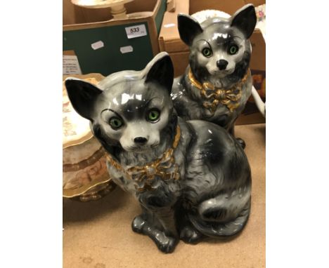 A pair of Staffordshire glazed pottery figures of seated cats with glass eyes, 31 cm hightogether with an early 20th Century 