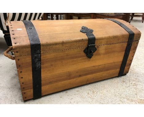 A modern teak dome top trunk as a treasure chest, the interior of the lid decorated with galleon and pirate on a desert islan