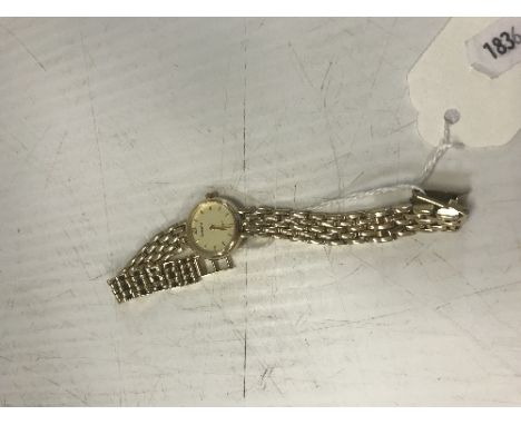 A ladies Accurist "gold" dress watch with 9 carat gold fancy chainlink bracelet, approx. 15 g weighable gold 