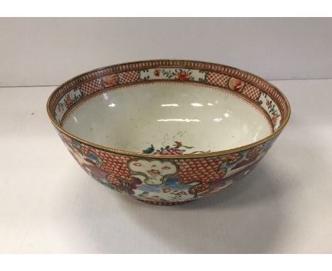 A Qianlong polychrome decorated famille rose bowl with all over decoration of figures in garden settings, a dog begging at a 