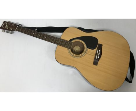 A Yamaha F310 acoustic guitar by YMMJ Co Ltd Indonesia with Fender soft case
