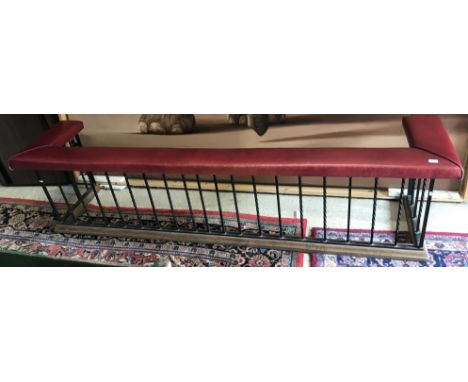 A 20th Century red leather upholstered and wrought iron barley twist railed club fender on an oak moulded edge base, 261 cm w