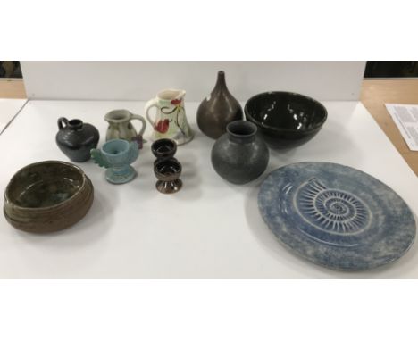 A collection of studio pottery wares including a Sue Schwarz rustic mottled green glazed bowl, approx 13 cm diameter, another