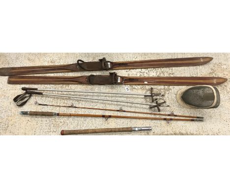 A pair of vintage wooden skis bearing label Bernard Sports and poles, a Sportex fibre glass sea fishing rod and a vintage fen