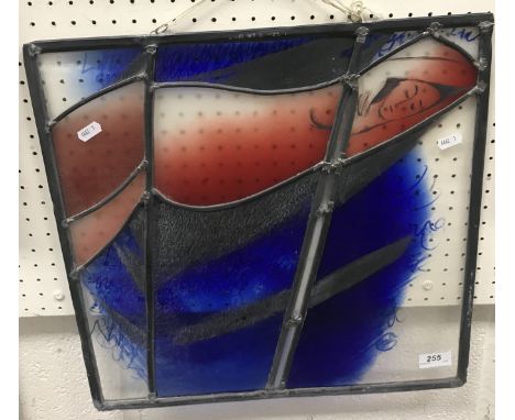 A modern stained glass panel depicting "Nude with indistinct writing", 45 cm x 45.5 cm 