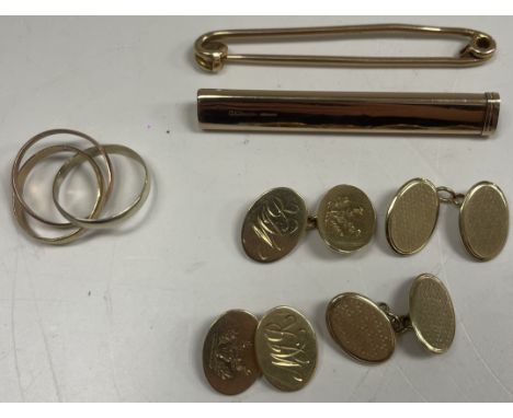 A collection of gold to include a 9 carat gold stock pin, a pair of 9 carat gold cufflinks of oval form with engine turned de