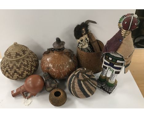 A collection of various tribal items to include a red pottery gourd-shaped jug, South Sudan / Congo, 17.5 cm high, a carved a