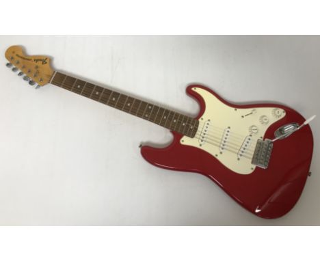 A Fender Stratocaster Contour Body style red electric guitar serial No. 300484 with Stagg soft case CONDITION REPORTS The mai