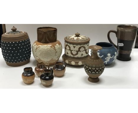 A collection of ten Doulton stoneware and other items including a silver rimmed simulated copper and leather silicon ware mug