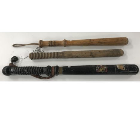 A large black painted and gilt decorated truncheon bearing transfer decorated Royal crest inscribed "Aimez Verite", with crow