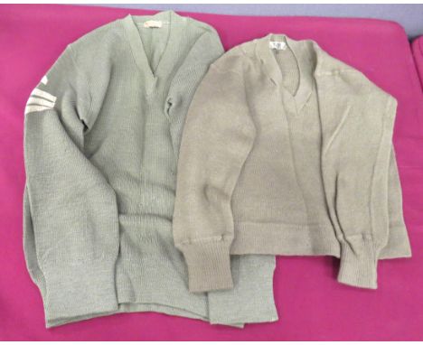 Two WW2 Australian Made V Neck Jumpers Dated 1942 consisting khaki green, woollen, V neck jumper. &nbsp;Right arm with white 