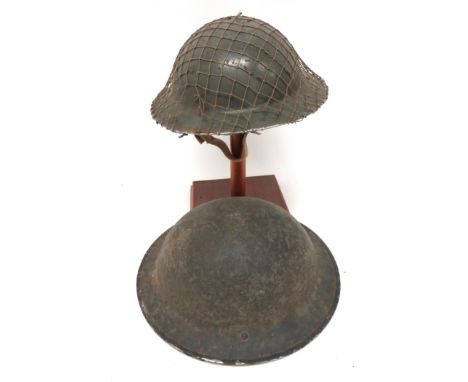 Two WW2 Pattern MKII Steel Helmets consisting grey painted helmet. &nbsp;Both sides of the brim with 3 drilled holes. &nbsp;B