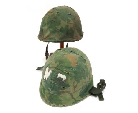 Two Post War American Pattern Steel Helmet green painted steel shells. &nbsp;Fibre inner helmet with webbing and leather line