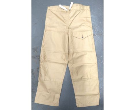 WW2 Windproof Drab Over Trousers Dated 1942 light khaki tan cotton over trousers. &nbsp;Front left leg patch pocket with butt