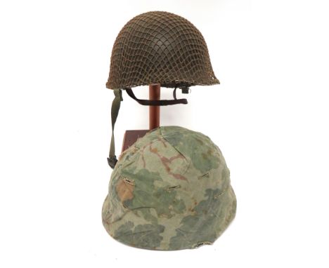 Two Post War American Pattern Steel Helmet green painted outer shells with swivel side bales. &nbsp;Fibre inner with webbing 