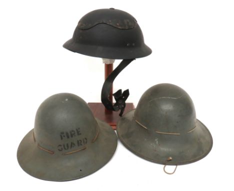 Three WW2 British Home Front Helmets consisting black fibre, multi panel construction, Cromwell helmet. &nbsp;Black treated l