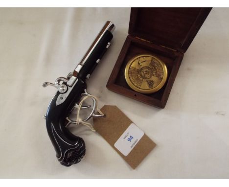A modern brass nautical style rotating calendar together with a lighter in the form of a flintlock pistol 