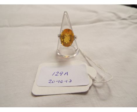 A 9ct white gold ring inset with large gold fire opal approx 7.56 ct flanked by diamonds, size O 