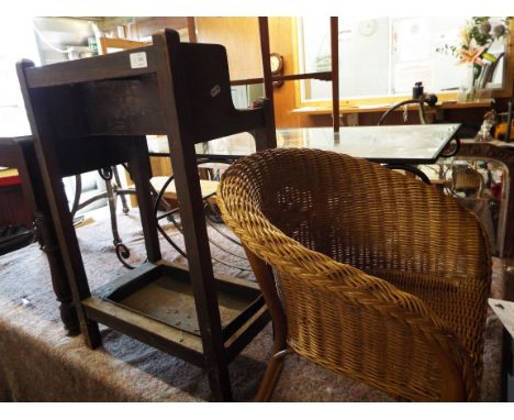 An oak umbrella stick stand together with a childs wicker armchair 