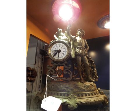 A French spelter mantel clock in the form of a young boy with bird, the enamel dial with Roman numerals and resting on stylis