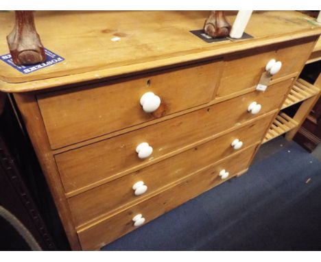 A Victorian pine chest of two short over three long drawers having ceramic handles