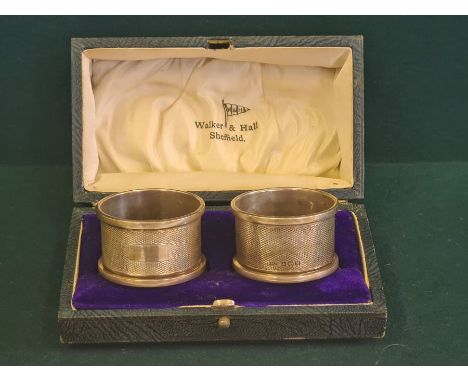 A pair of Broadway &amp; Co engine turned napkin rings, Birmingham 1936 in associated Walker &amp; Hall fitted box.