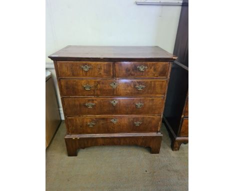 An early 18th Century walnut chest of 5 drawers, quarter veneer figured walnut top with geometric herringbone inlays upon bra