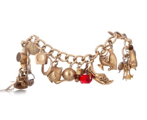GOLD CHARM BRACELET the curb link bracelet with charms including a boot, lamp, teapot and top hat, some marked for goldQty: 4
