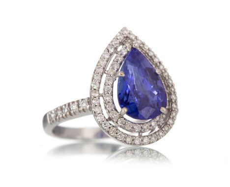TANZANITE AND DIAMOND RING set with a pear shaped tanzanite within a double halo of diamonds, on diamond shoulders, marked 75