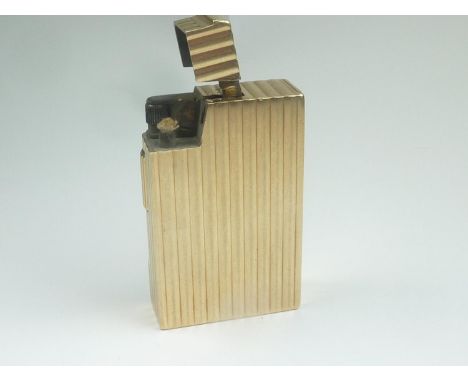 Good 9ct gold cigarette lighter, ribbed all over, petrol, Birmingham 1948. 49mm x 31mm x 12mm.67g gross. 