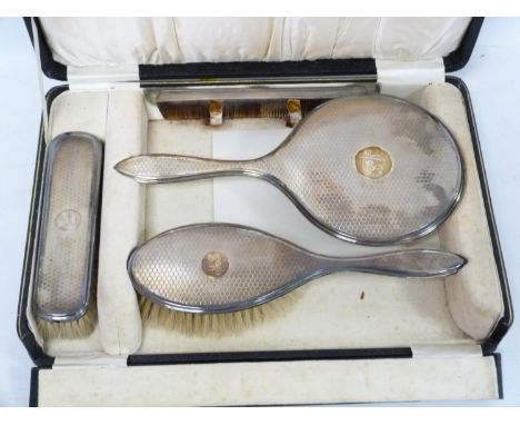 Silver toilet set, engine turned, two brushes, mirror and comb, 1929. Cased.&nbsp;&nbsp; 