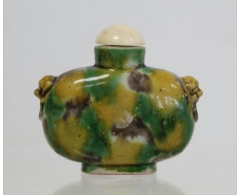 Chinese porcelain snuff bottle with "egg and spinach" glazes, mask head handles, four character mark and ivory stopper, 5cm h